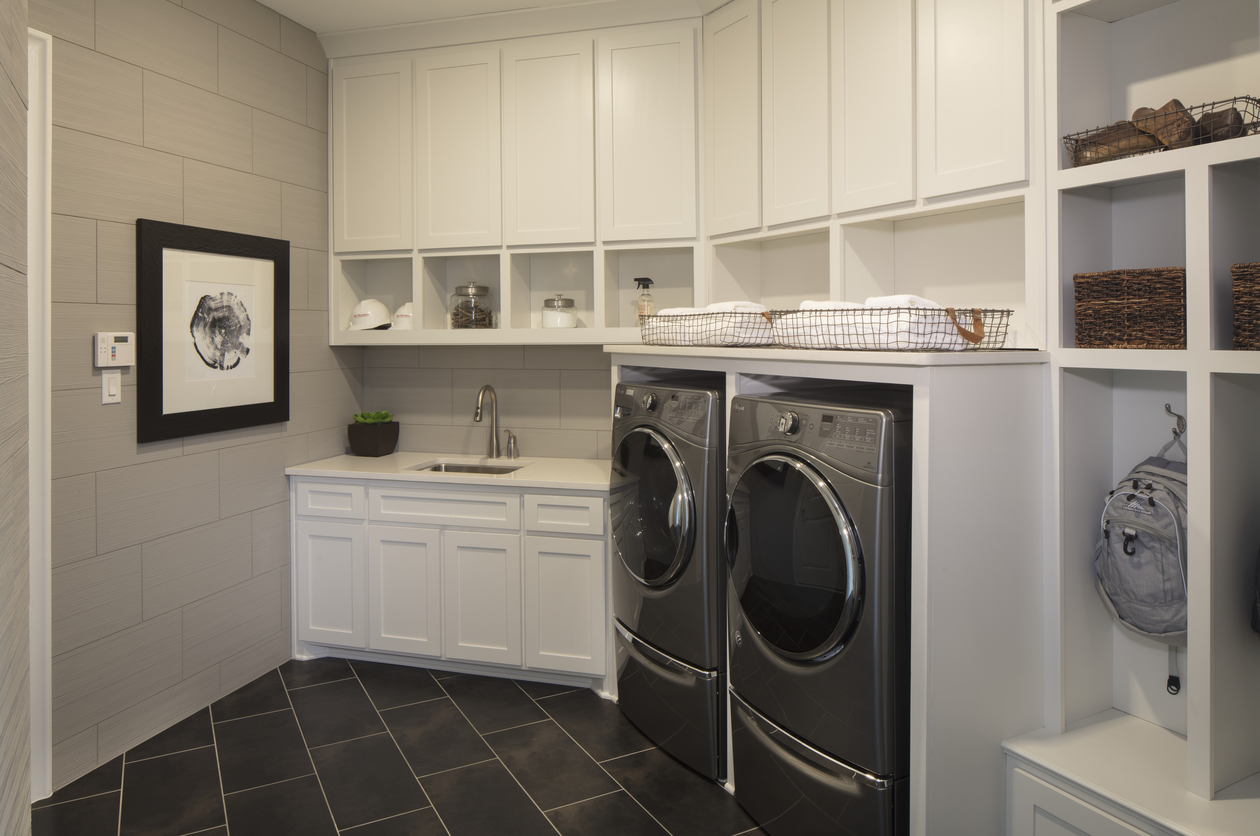 Mudroom with laundry and storage compartments.