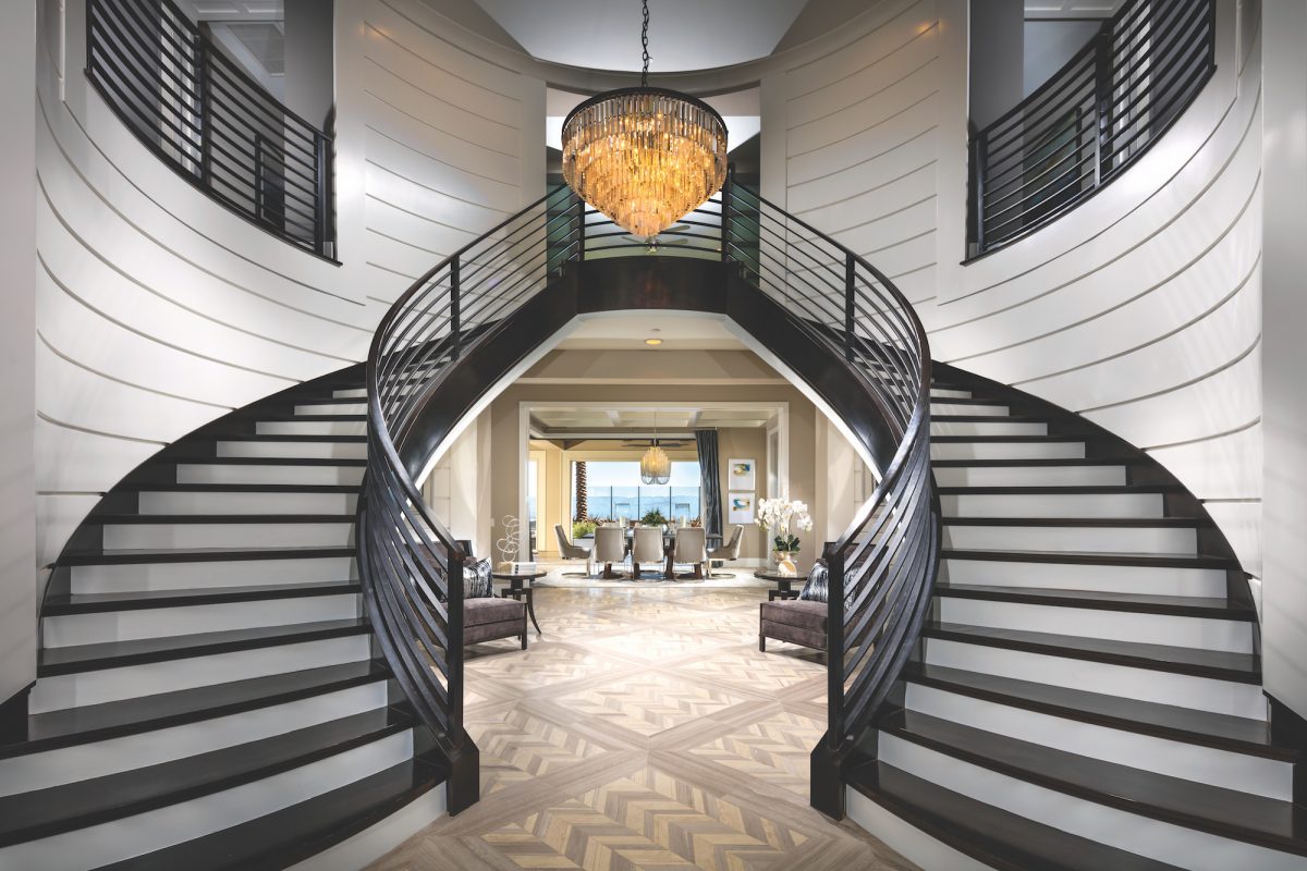 Entrance to a house with a dual staircase.