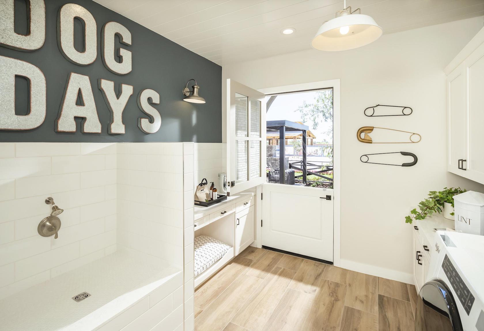 Laundry room with dog bed and shower.