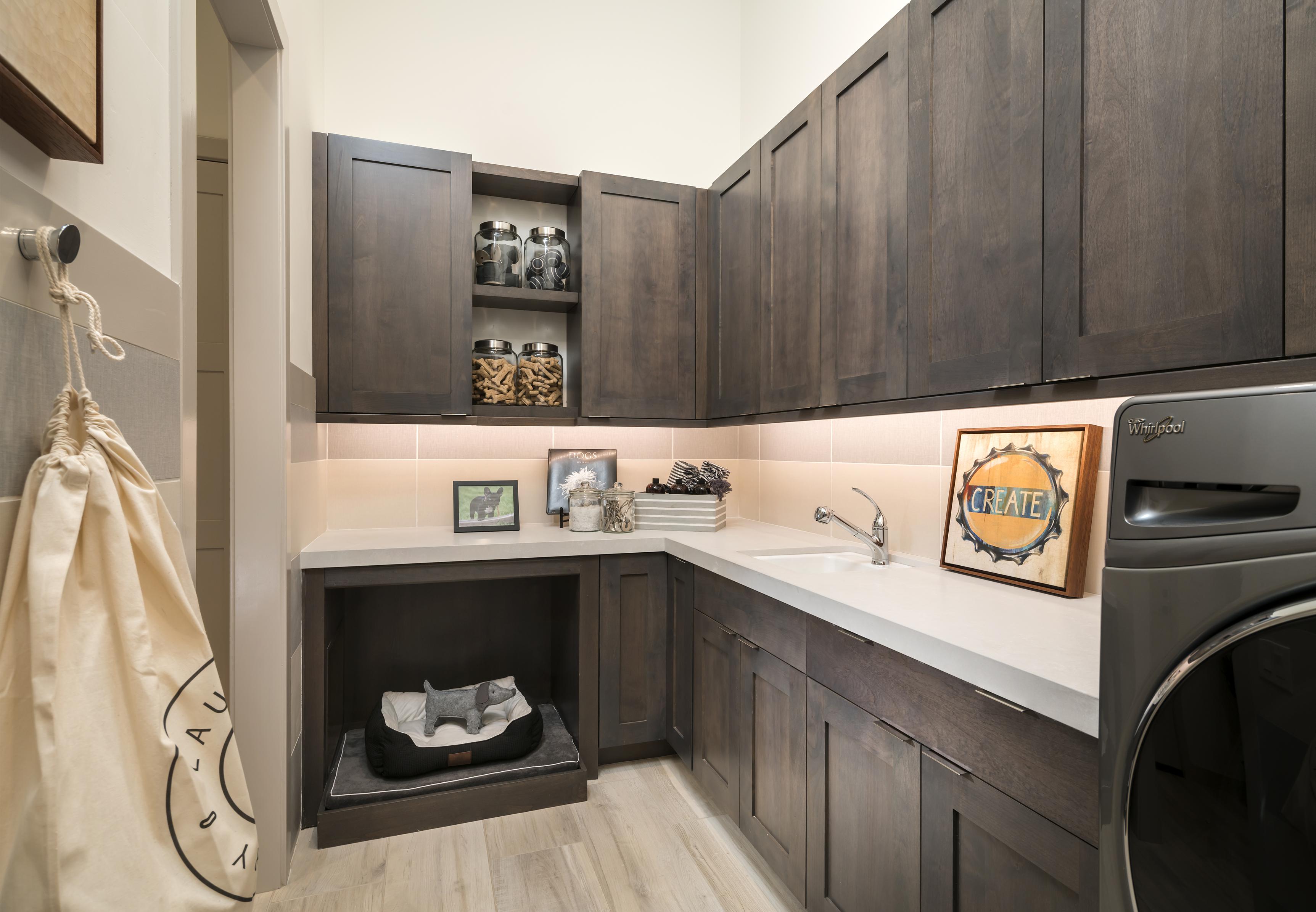 Laundry room with a dog bed in a nook.