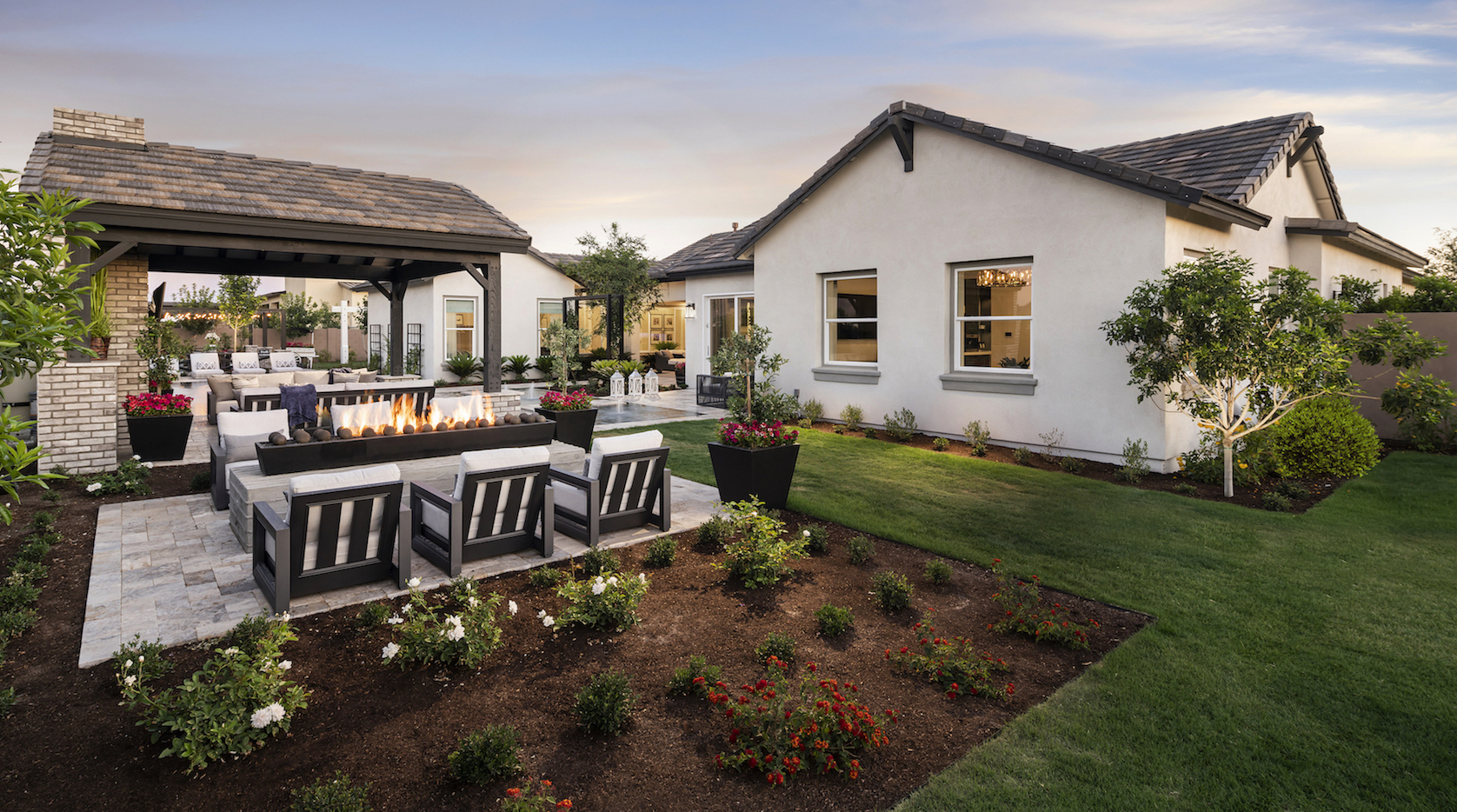 Small backyard with landscaping, fire pit and outdoor seating.