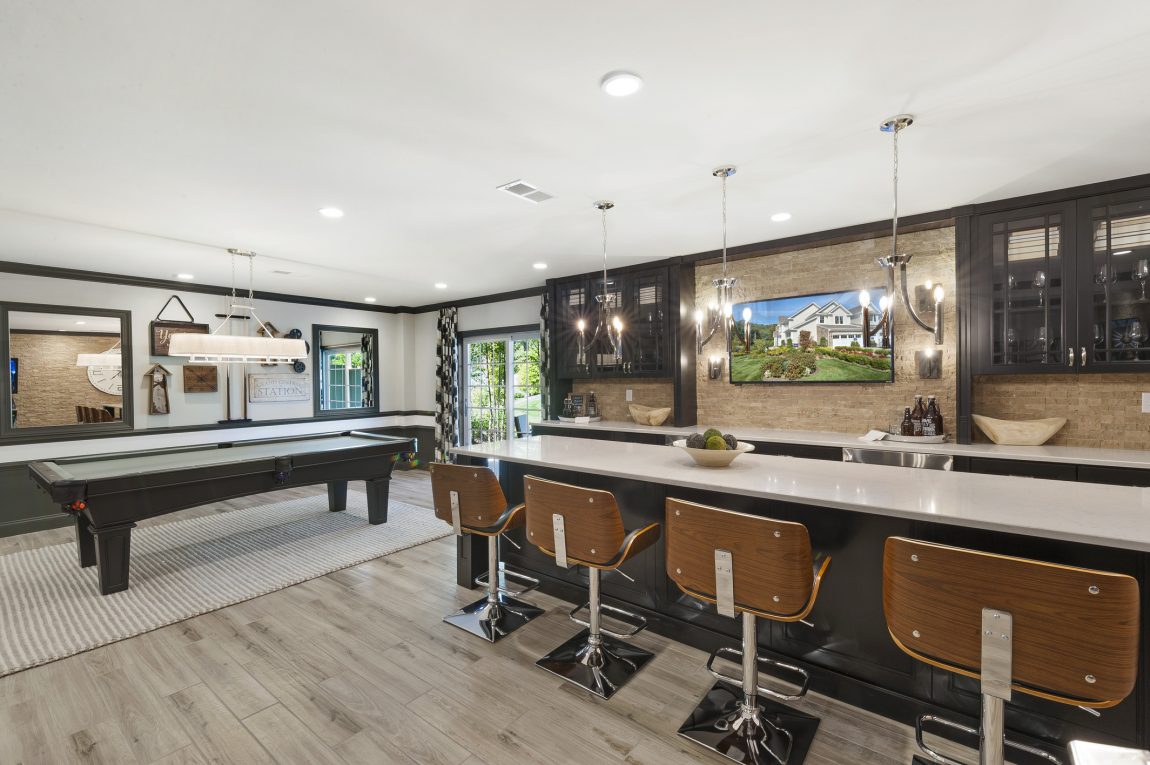 Basement bar in a house with a pool table.