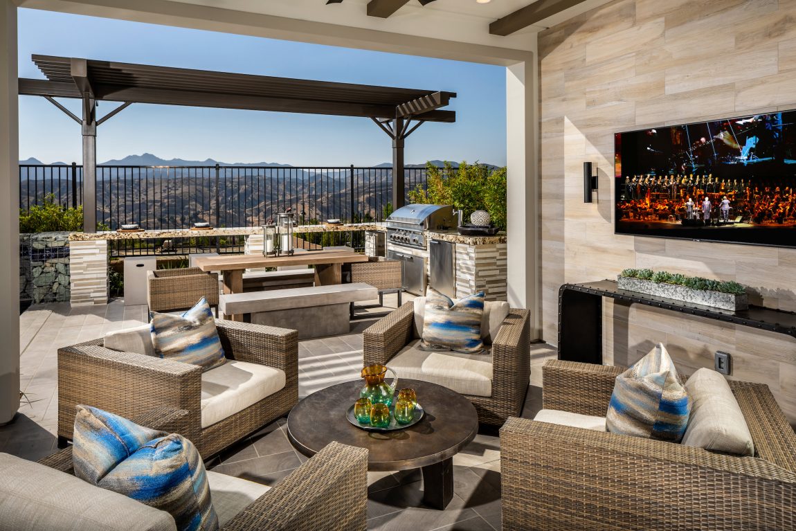 Patio with a grill at a tv.