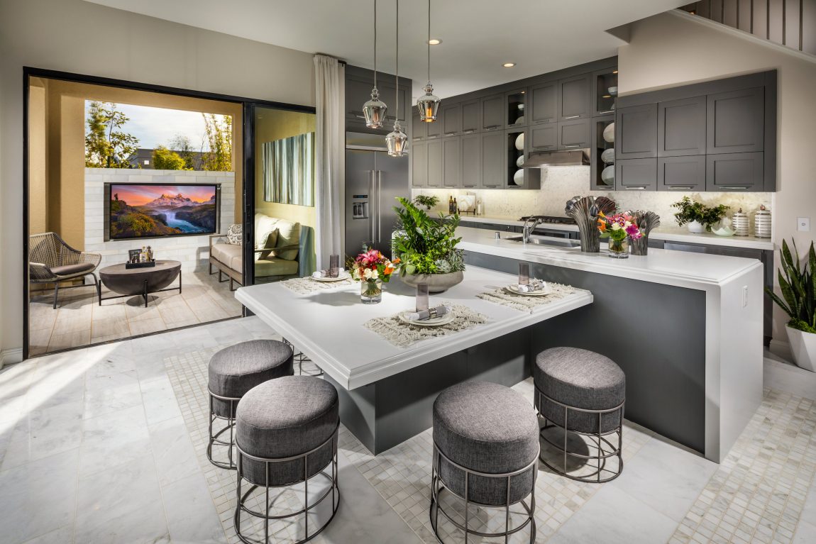 Kitchen opening to an outdoor area with tv.