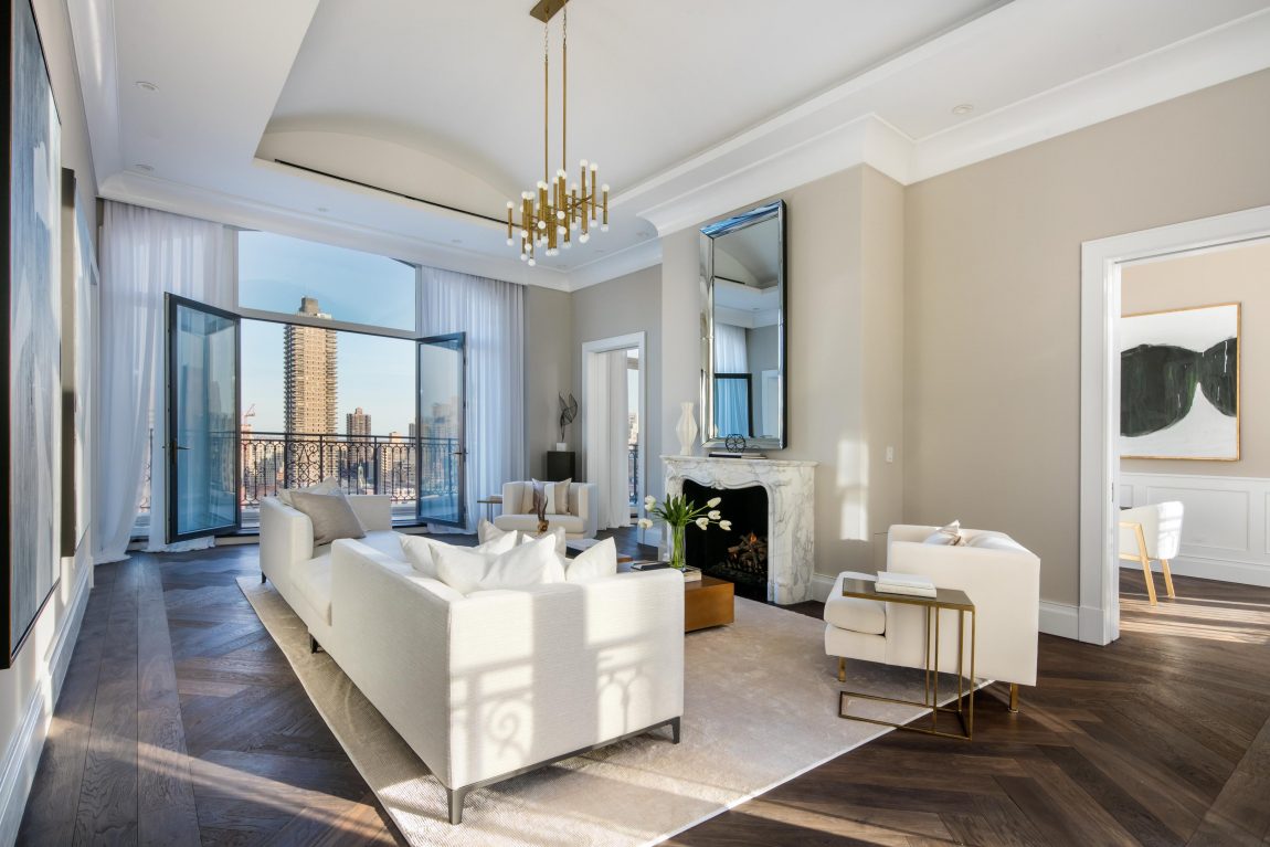 A living room with glass doors that open up to a terrace area