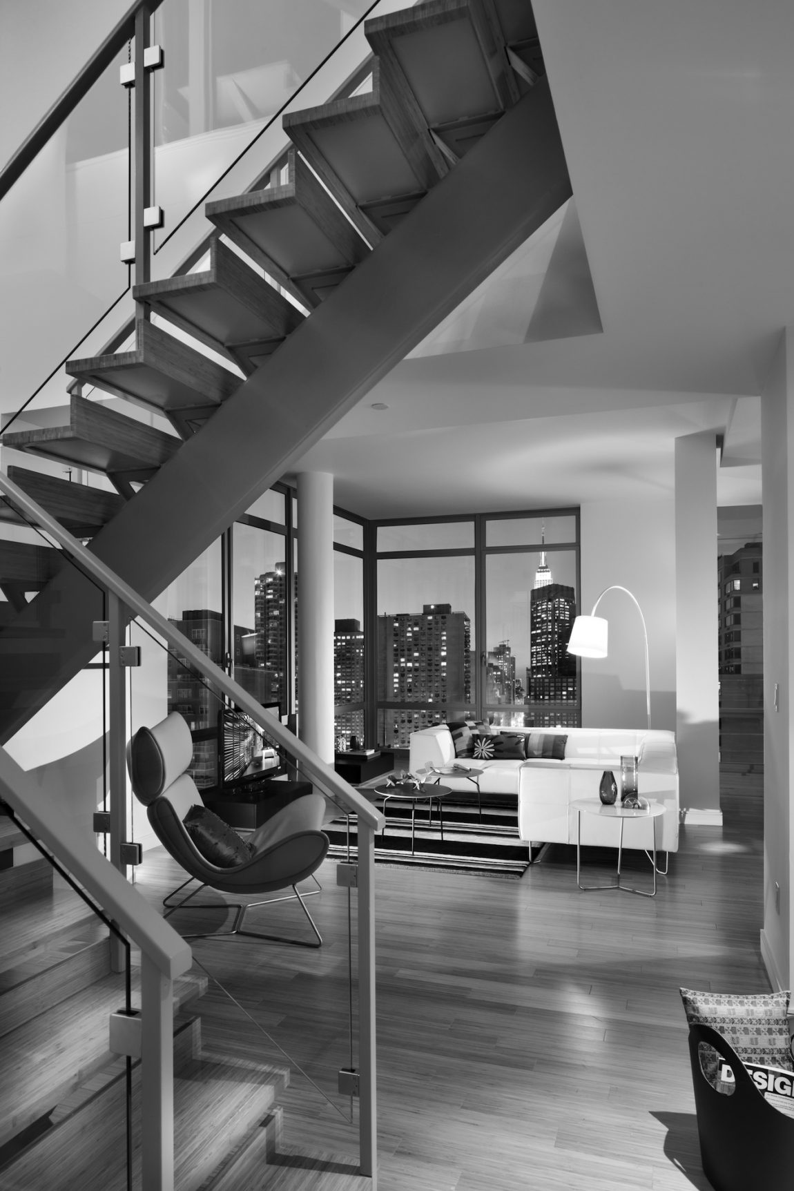 A staircase, living room, and view of New York City.