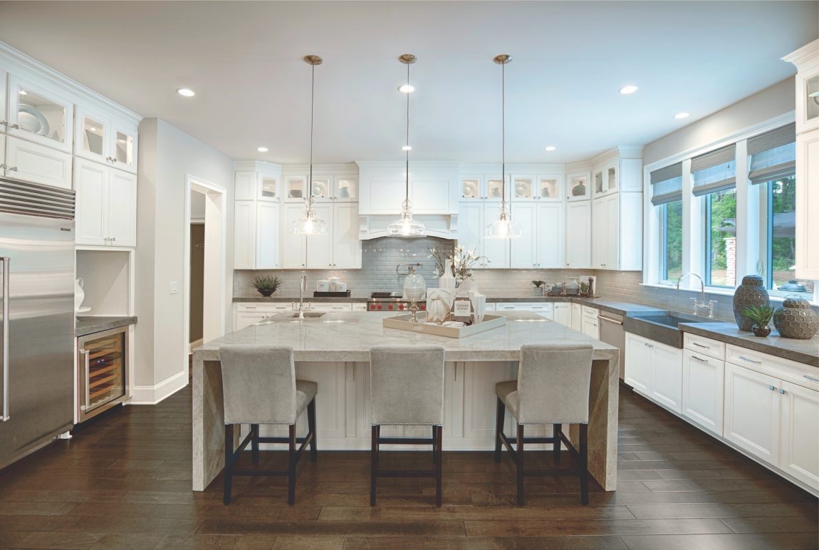 White kitchen with island and pendant fixtures