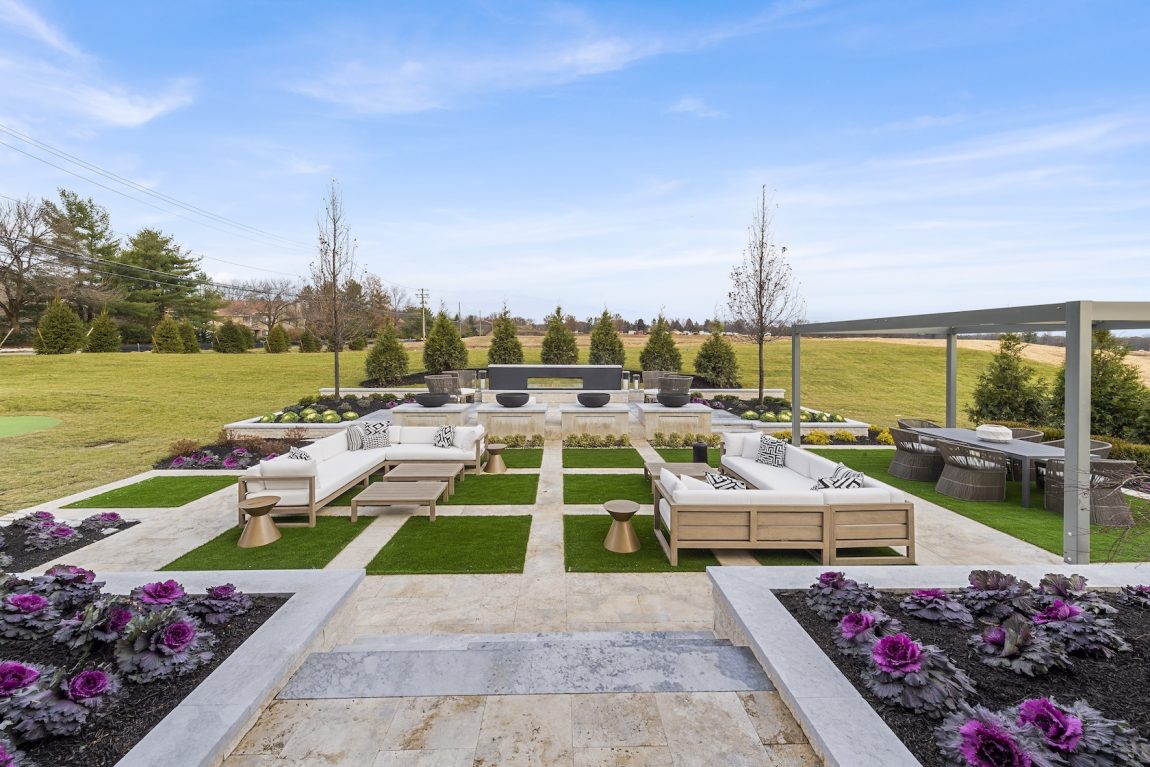 Landscaped backyard with outdoor living area during winter climate.