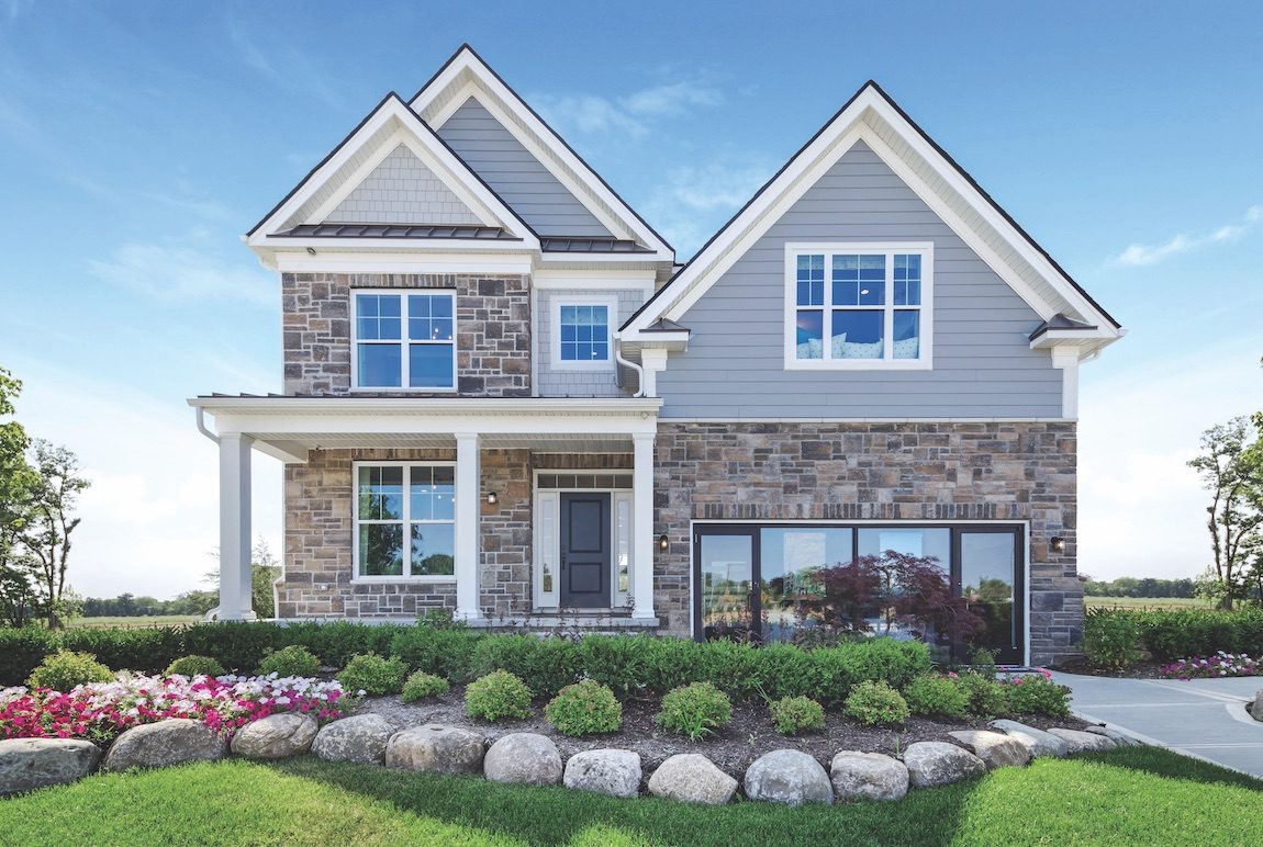 Front yard landscaping with colorful flowers and greenary.