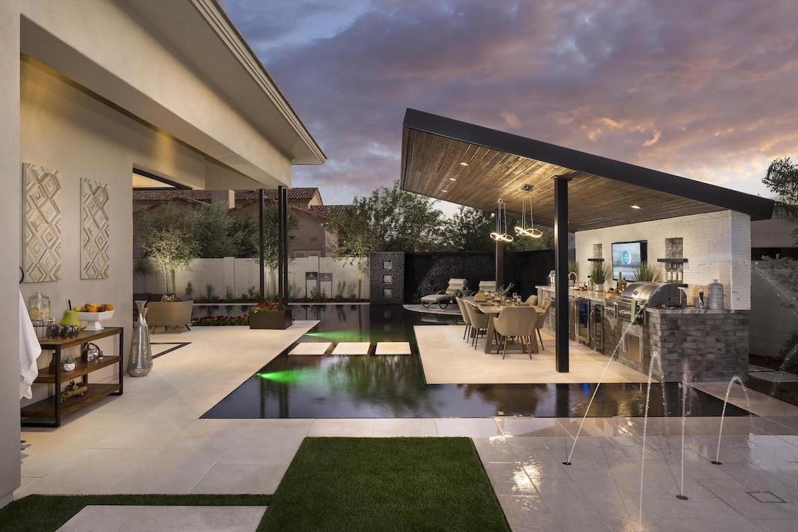 Outdoor pool with awning and entertainment area. 