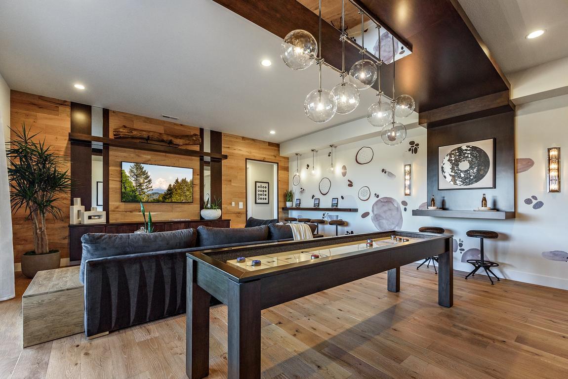 Basement with modern lights fixtures and table games