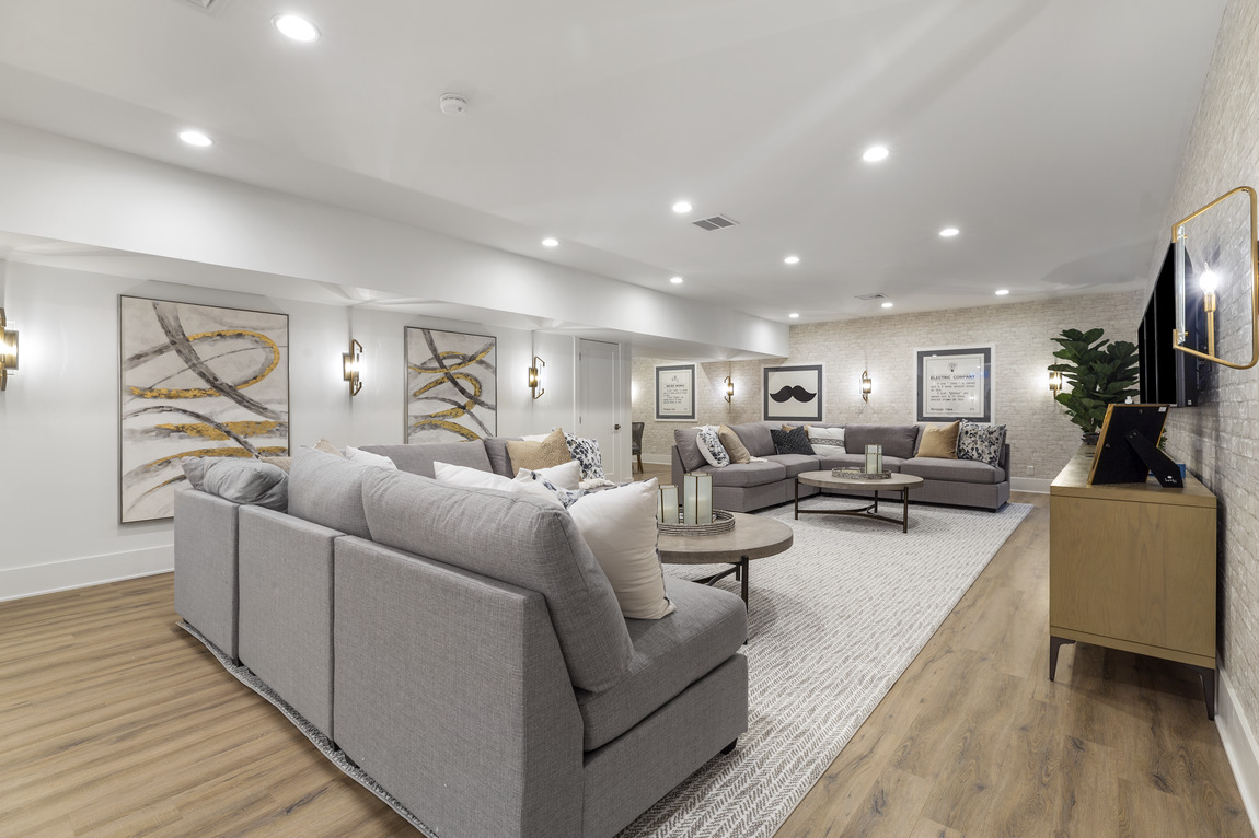 Basement with grey and tan tones; large and cozy
