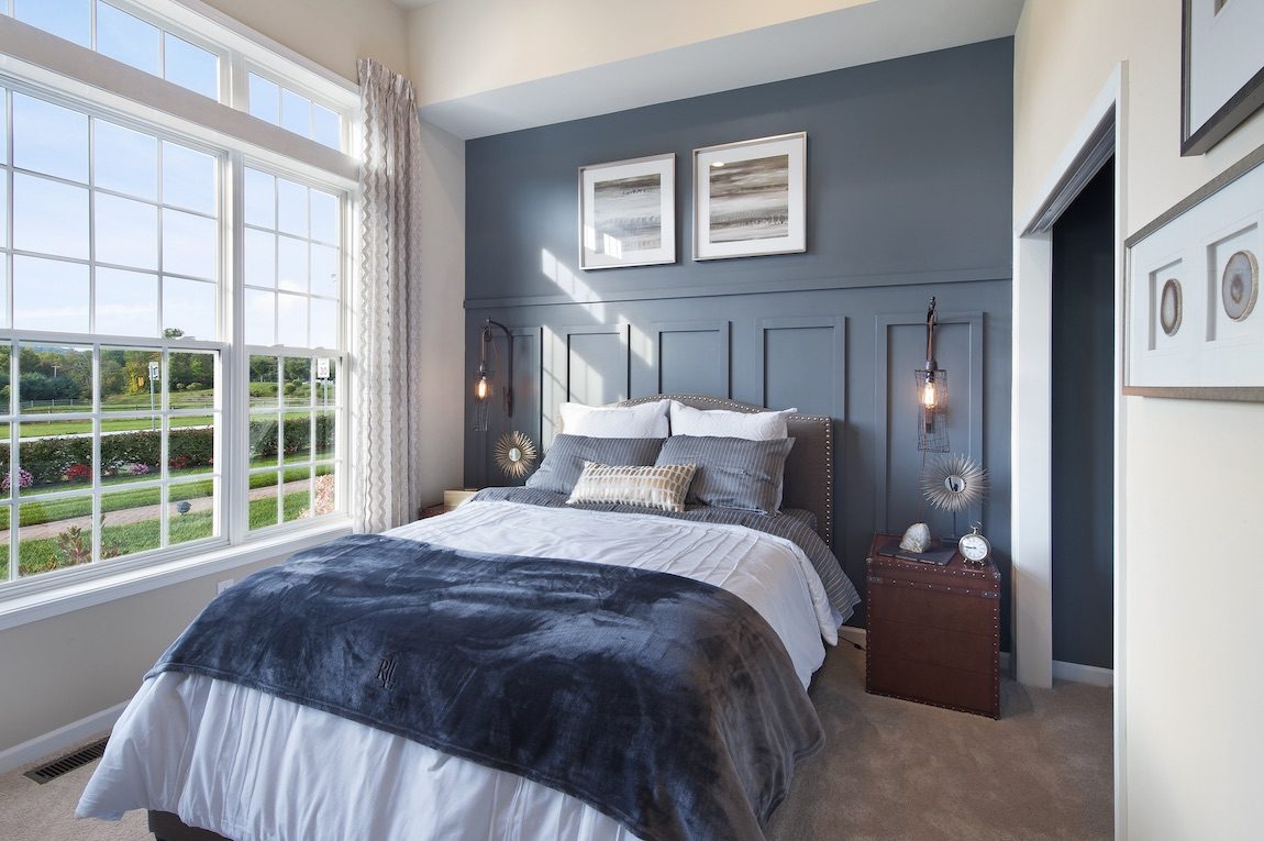 Bedroom with blue accent wall. 