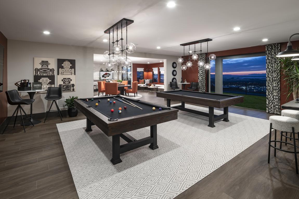 Game room basement with modern lighting and pool tables