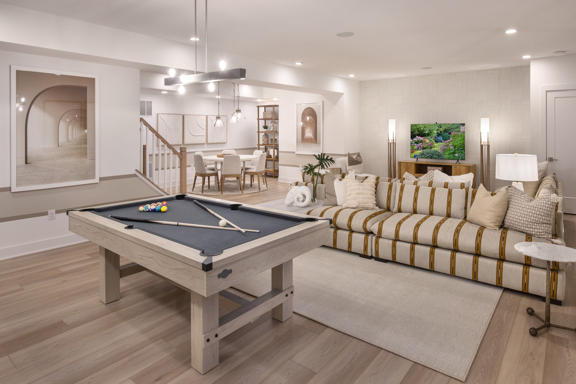 Finished basement with earth tones, light tan, and a pool table