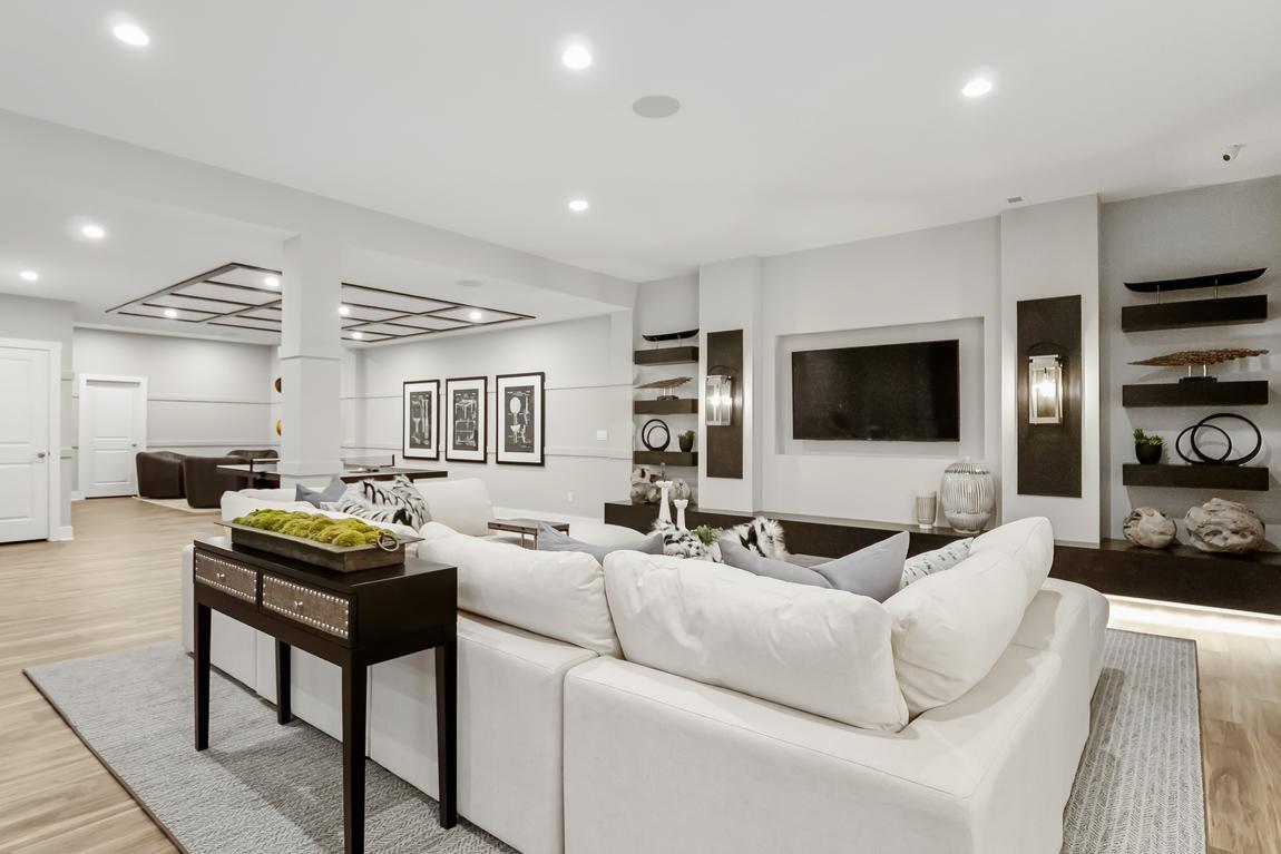 Black and white expansive basement with television