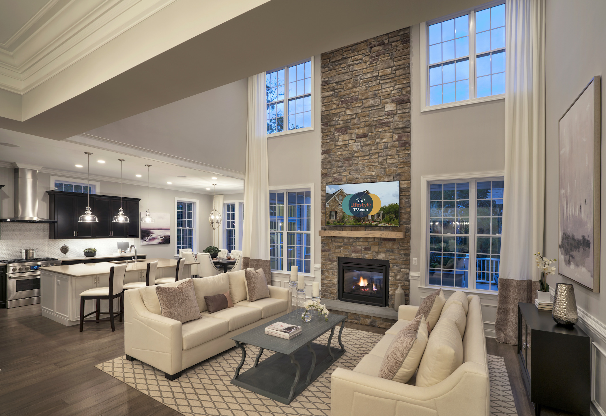 Impressive great room featuring stone fireplace and ample natural lighting.