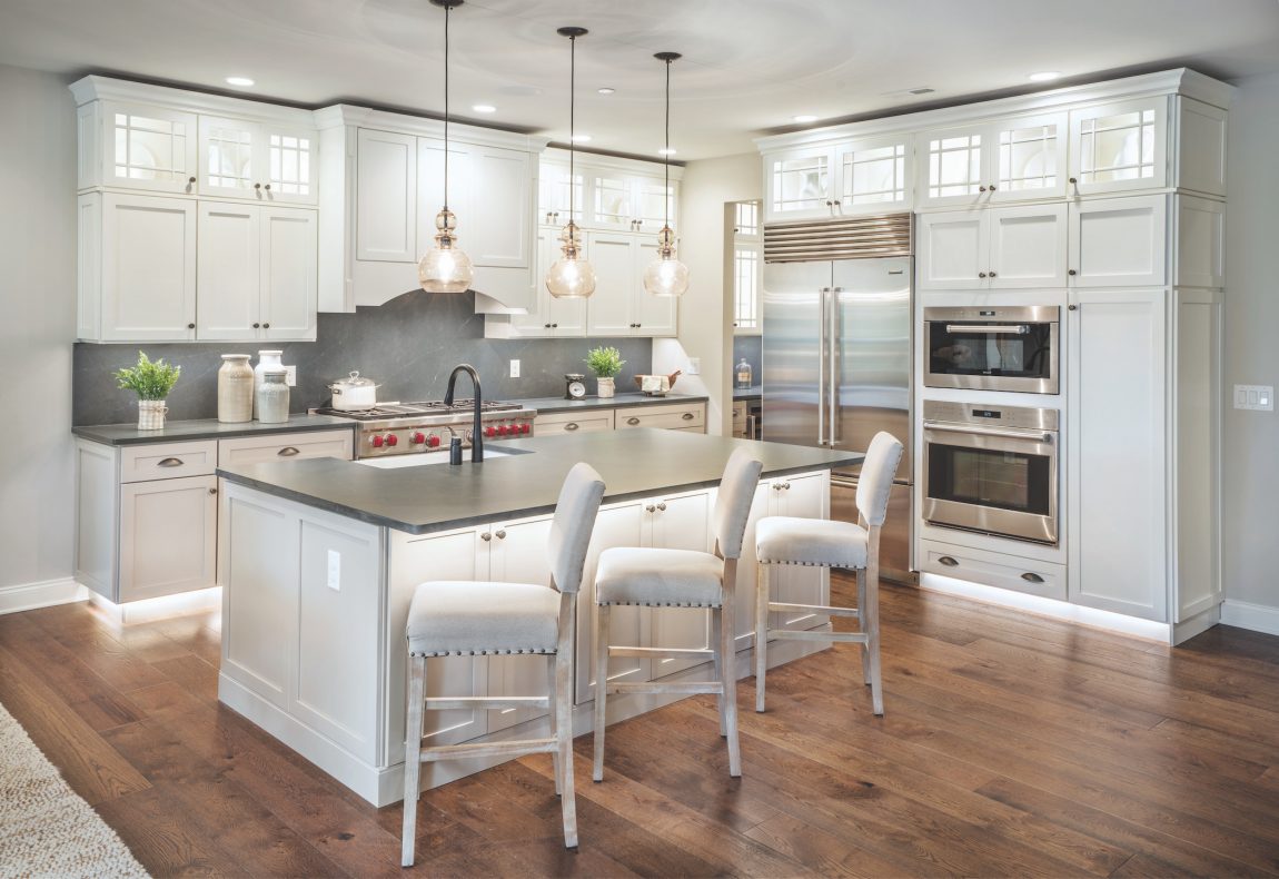 Modern farmhouse kitchen featuring large island and pendant lighting