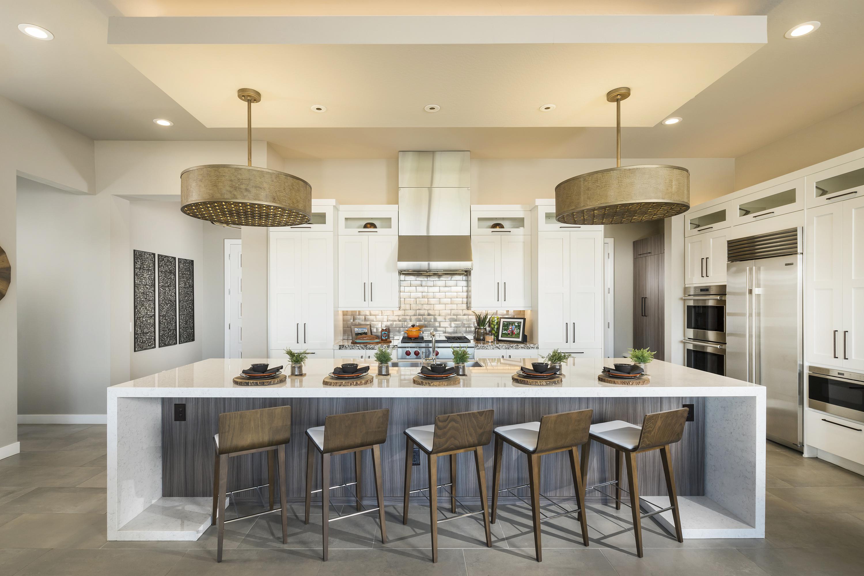 Open-concept kitchen with tremendous island and matching pendant fixtures.