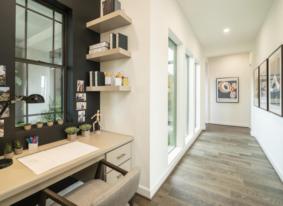 Hallway study nook with ample desk space and shelving.