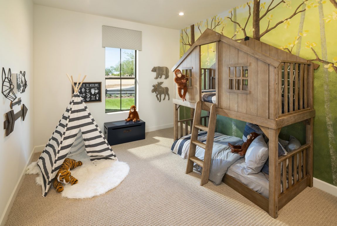 Creative kids bedroom featuring treehouse style bunkbed and jungle theme.