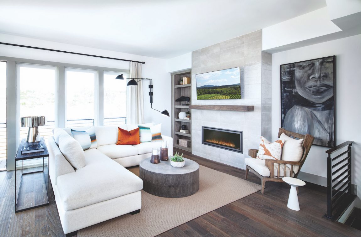 Sleek family room boasting fireplace and TV.
