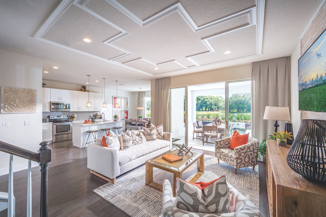 Great room with white and wood furniture and ceiling accent