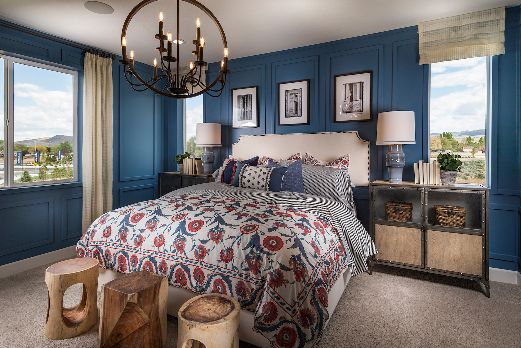 Bedroom with blue painted walls and modern chandelier.