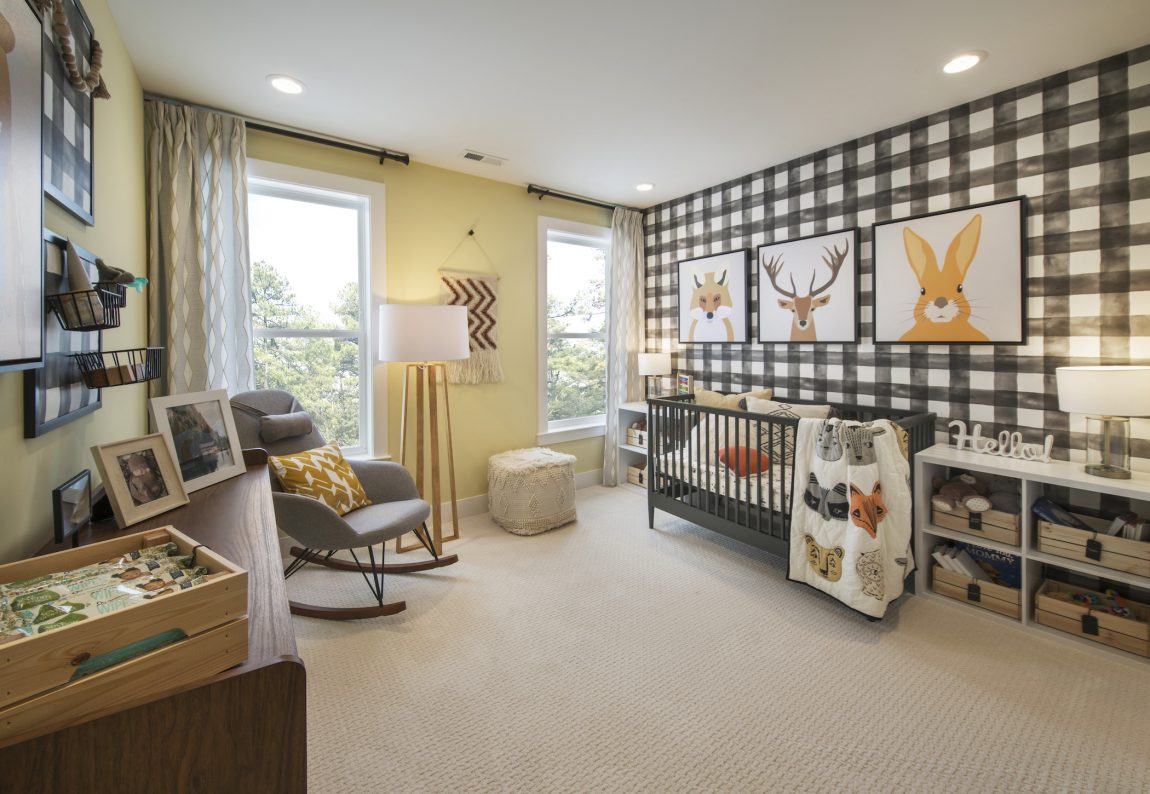 Baby's room highlighted by light, geometrically painted walls.