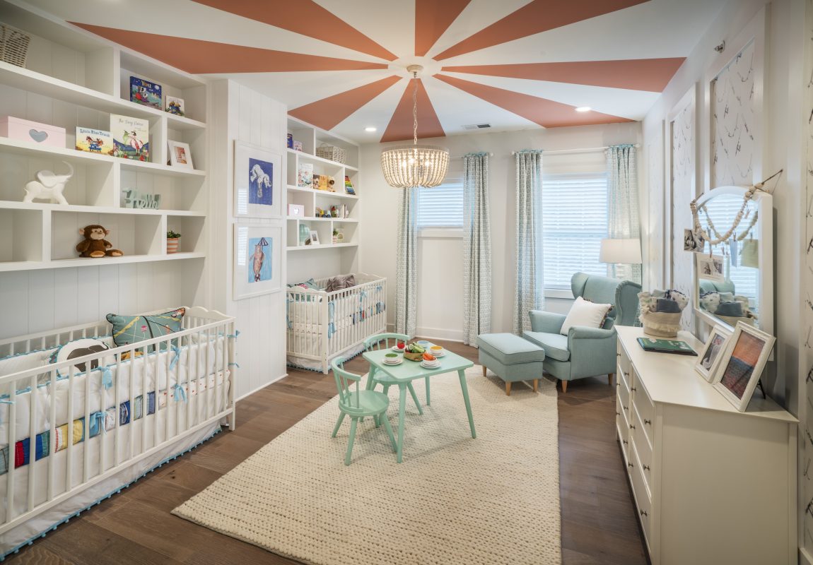 Nursery featuring spectacular two-toned ceiling and pendant lighting fixture.