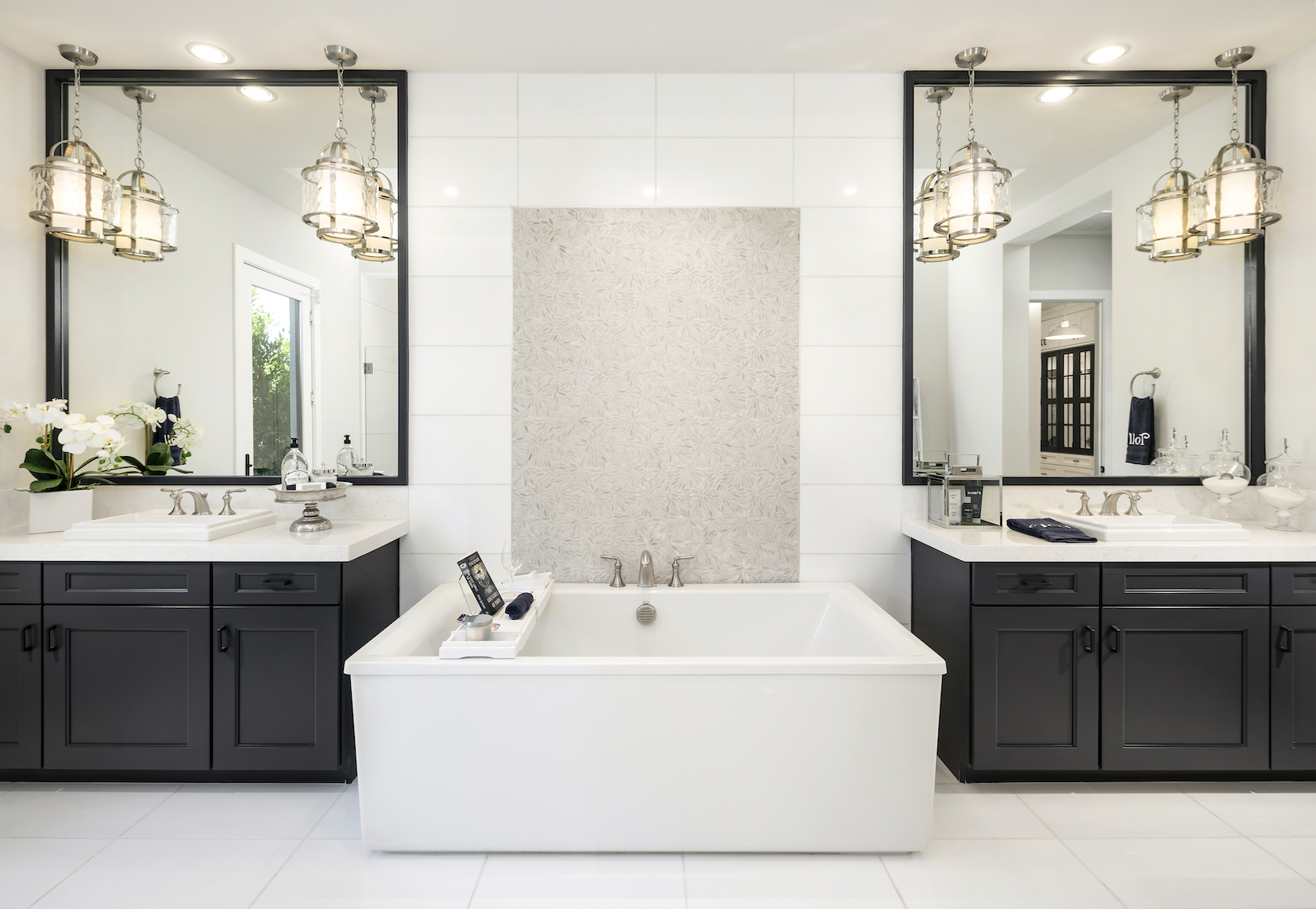 White bathroom with center tub and double vanity.