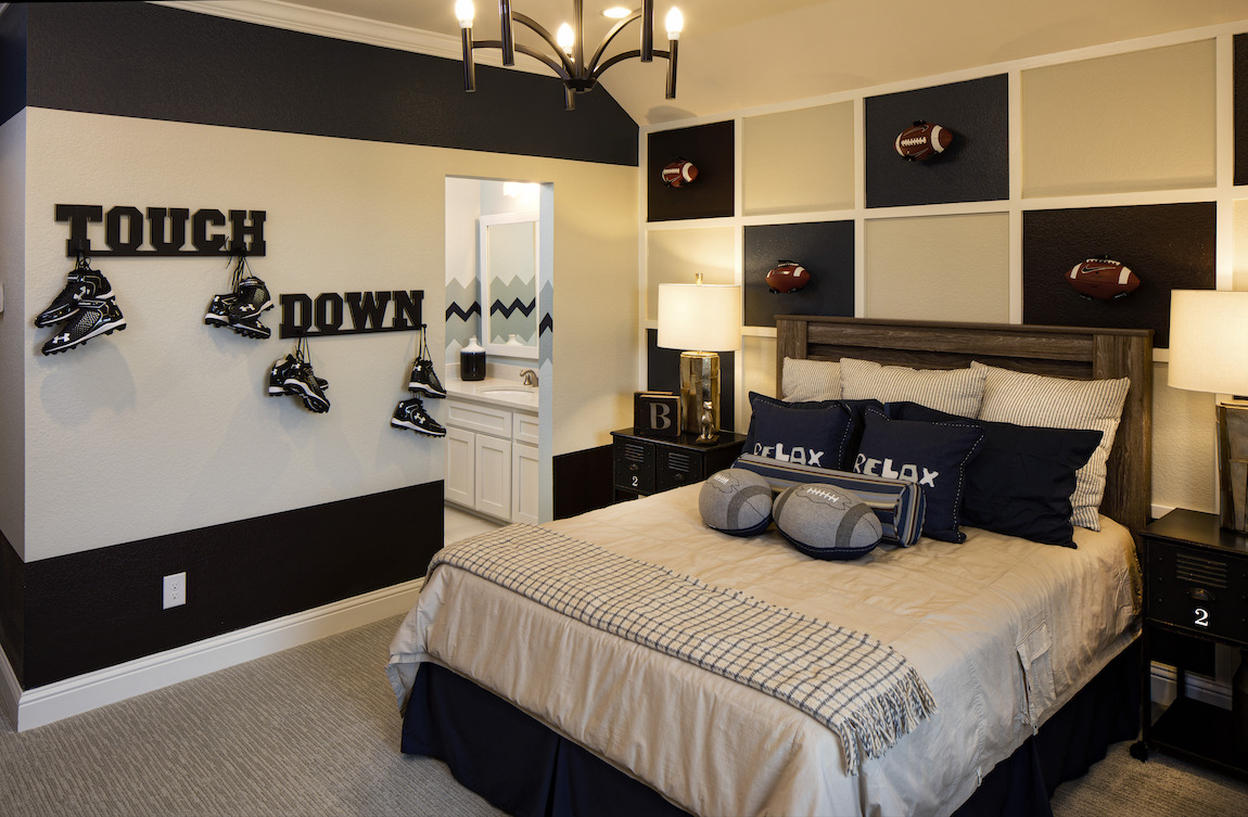 Teen bedroom with checkered wall design and lettered wall racks