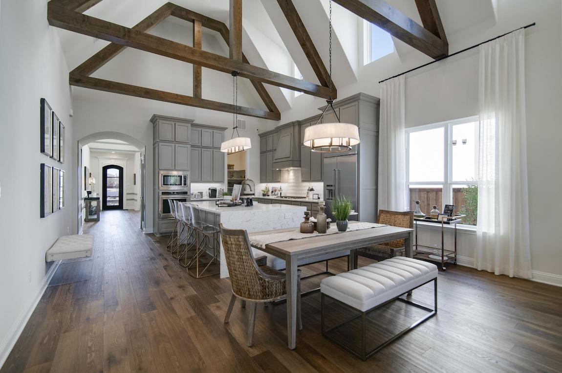 Great room and kitchen highlighted by valuted beam ceiling