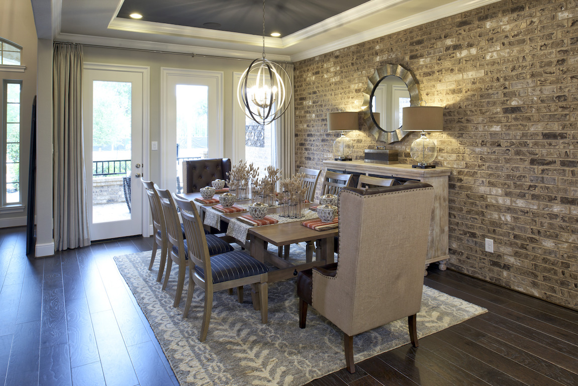 Formal dining room featuring tray ceiling and modern ring chandelier