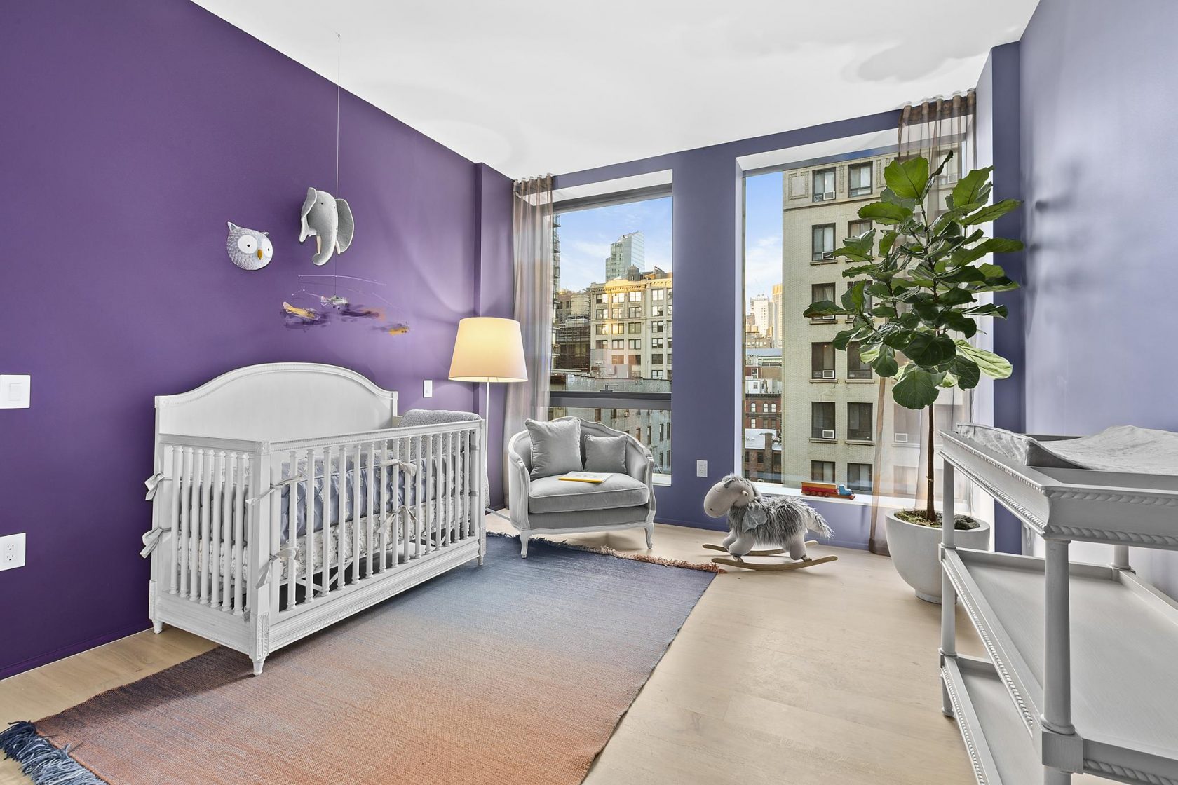 Baby room featuring a bold, vibrant purple color scheme