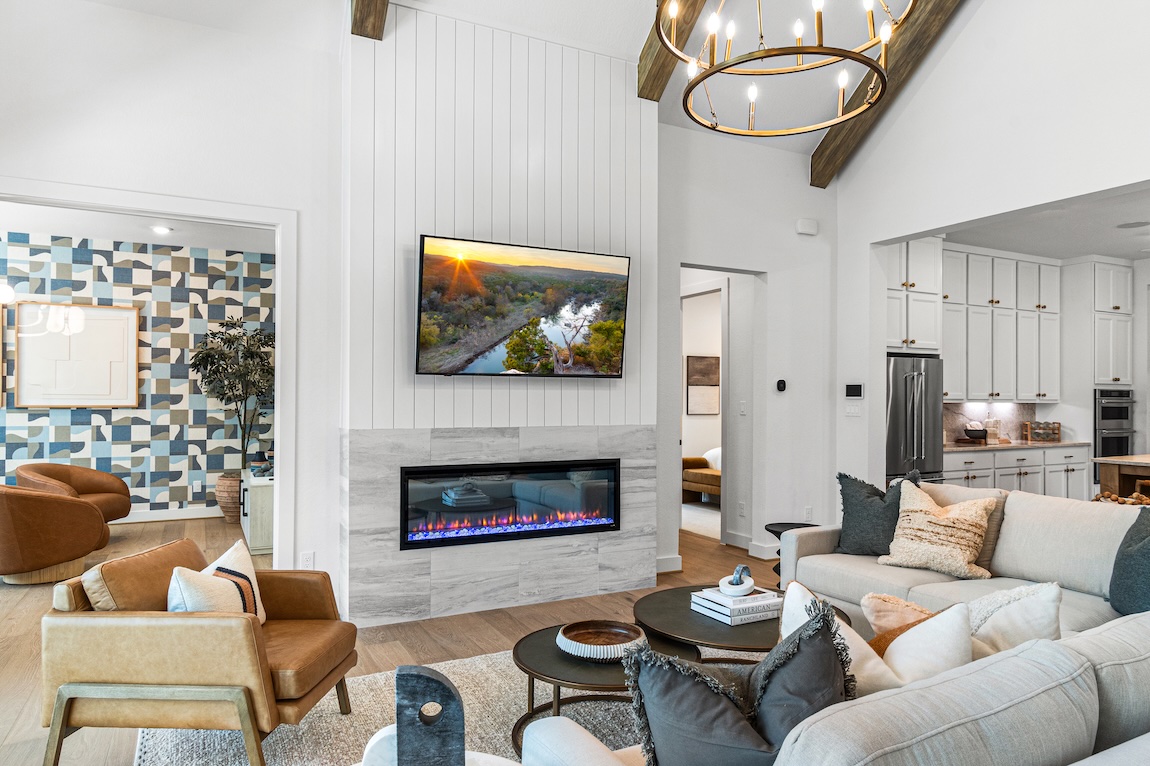 great room with fireplace and chandelier