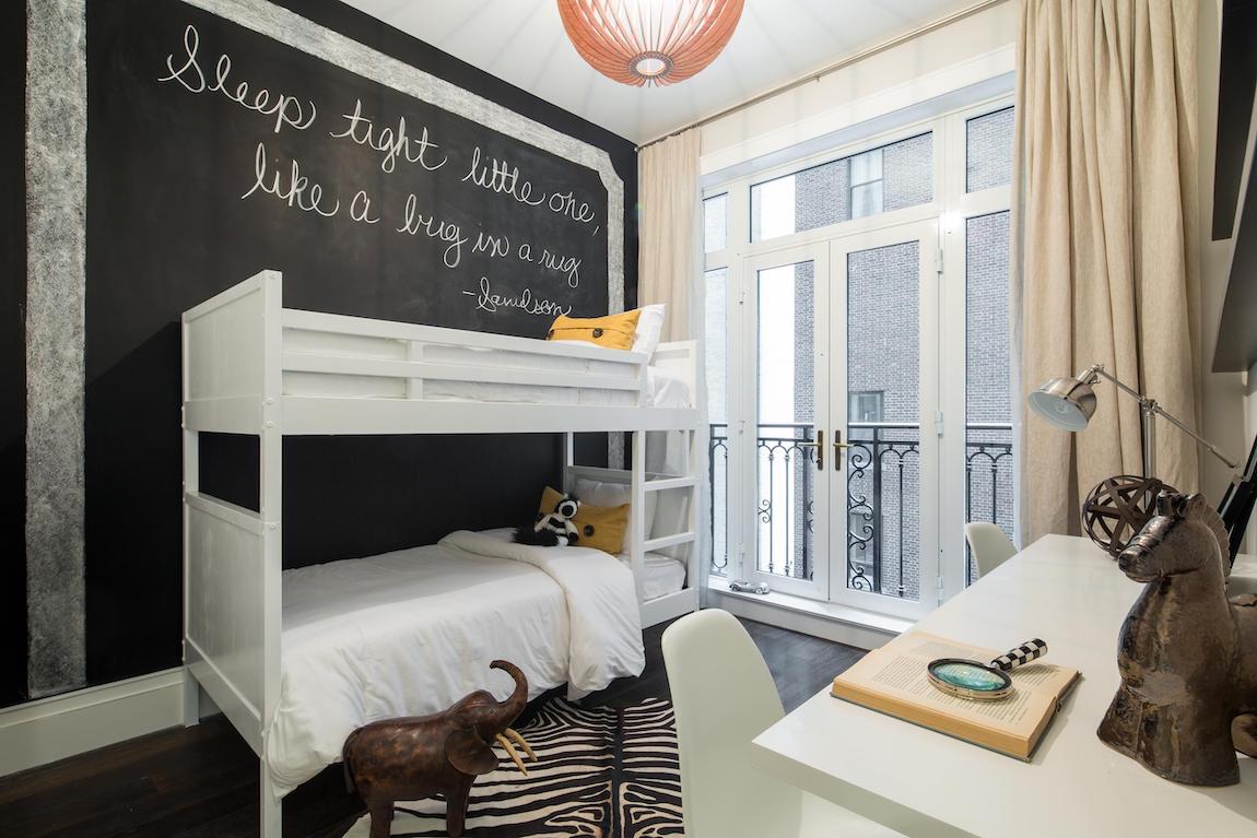 Luxury bedroom featuring bunk beds and chalkboard perfect for a dorm room design