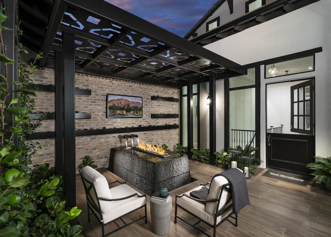 Tucked-away outdoor area featuring tv and awesome fire pit surrounded by water