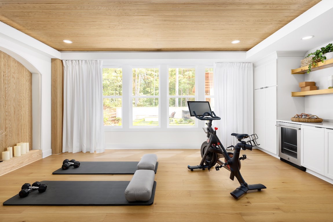 modern home gym with Peloton and yoga mats