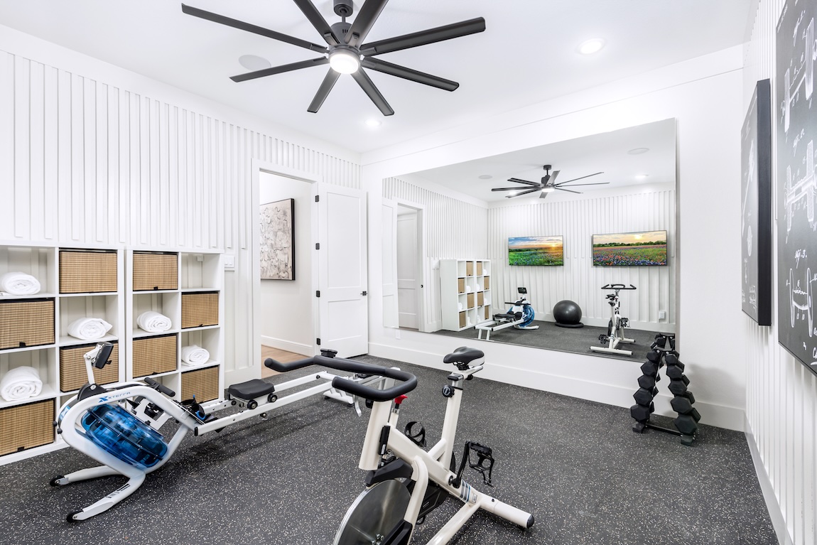home gym with equipment and mirrors