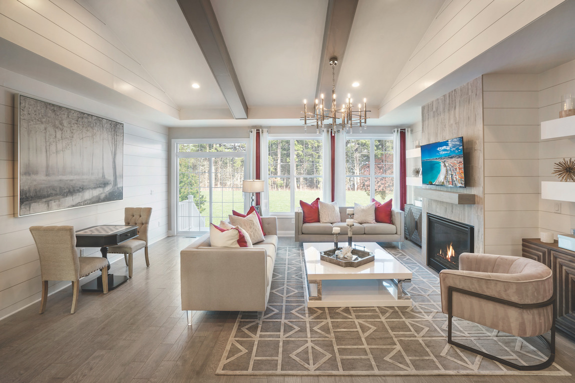 Modern living room with wood beam ceiling & shiplap walls.
