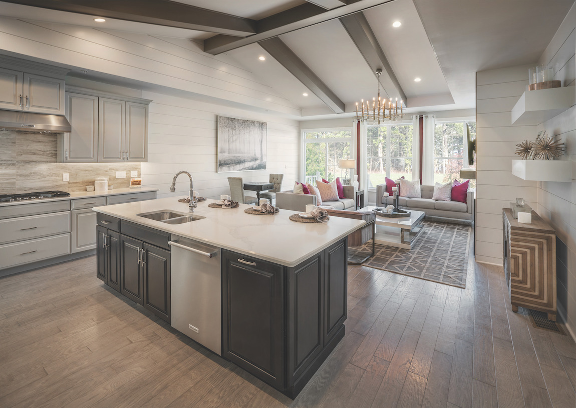 Farmhouse-inspired kitchen with wood beams and shiplap walls.