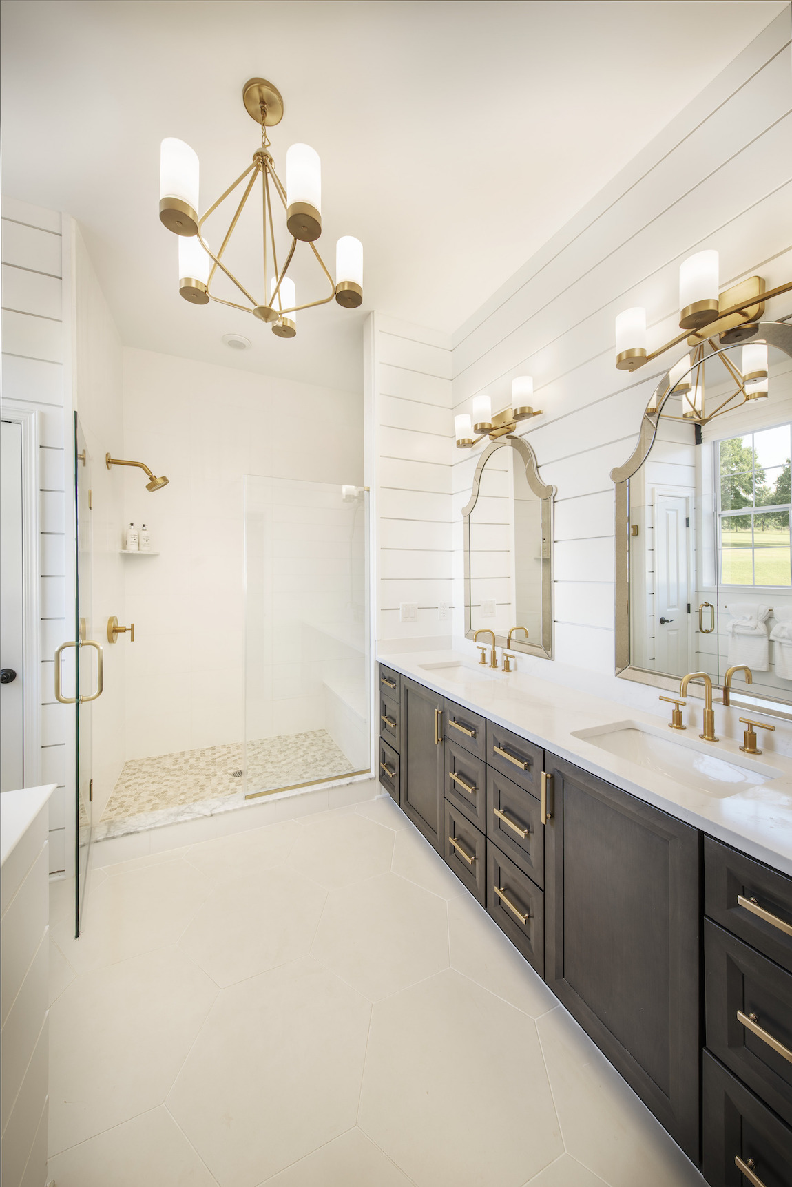 Modern bathroom with shiplap siding & gold accents.
