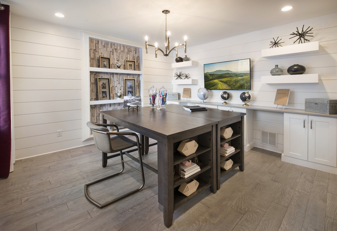 Hobby room with walls accented with a patterned bookshelf.