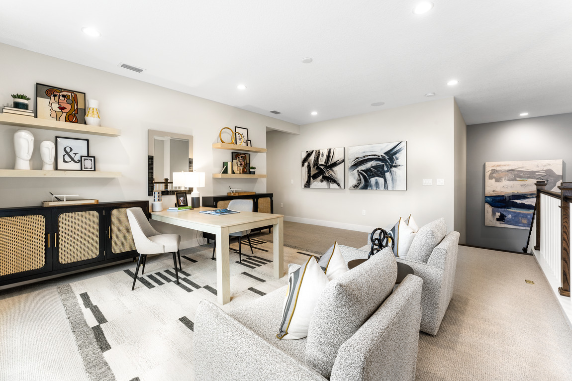 Home office with baton cabinet and white and gray armchairs