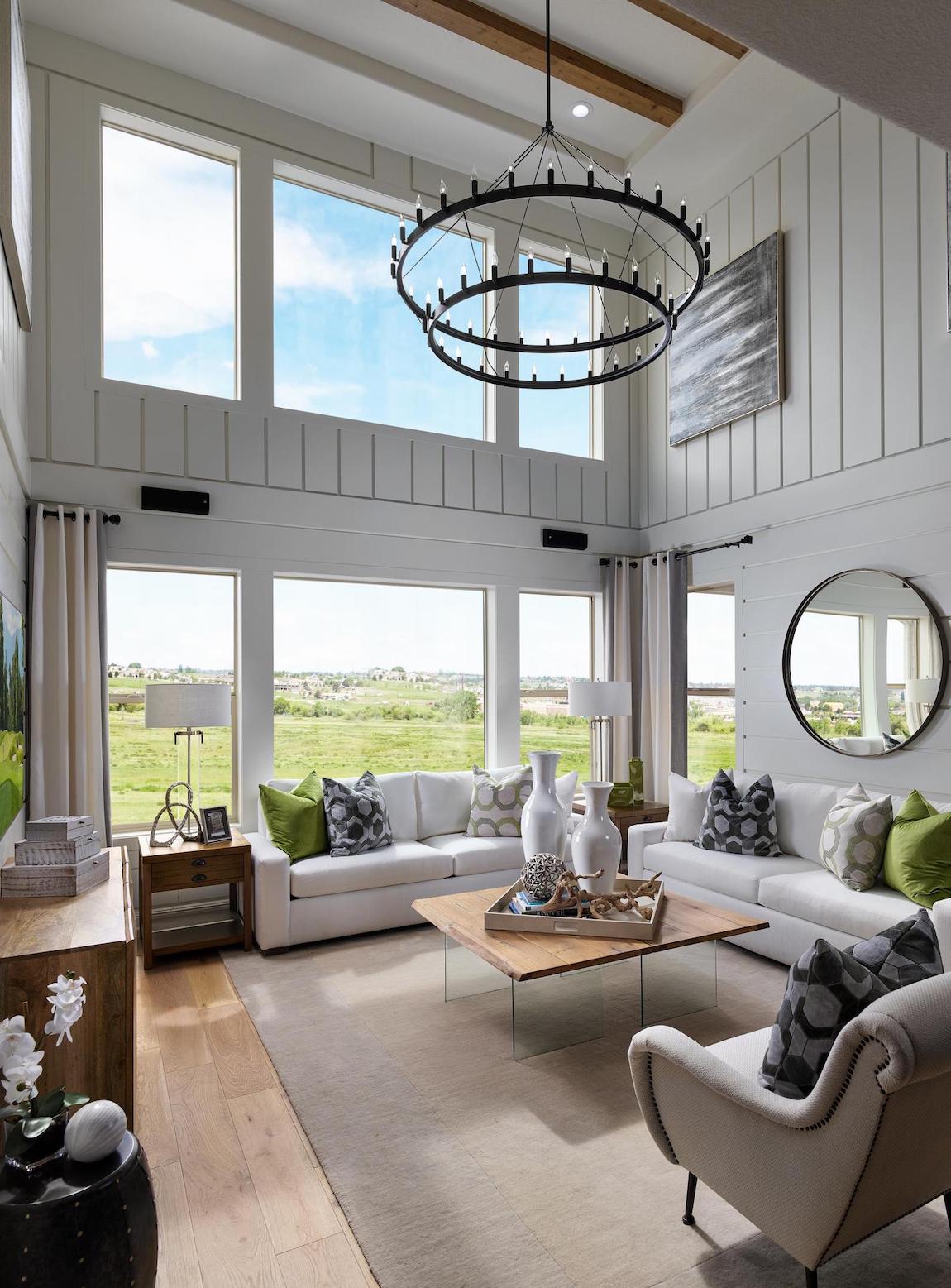 Living room with ample natural lighting & a half-wall of vertical shiplap.