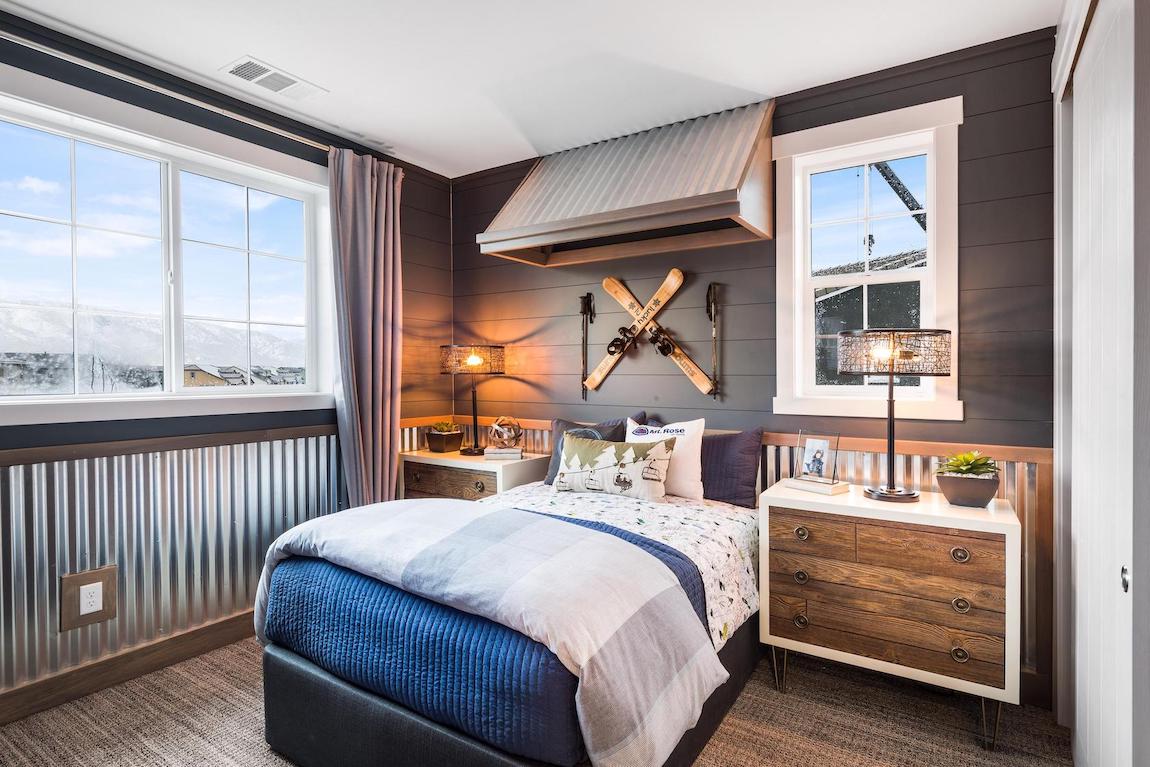 Kids bedroom with dark painted shiplap walls.