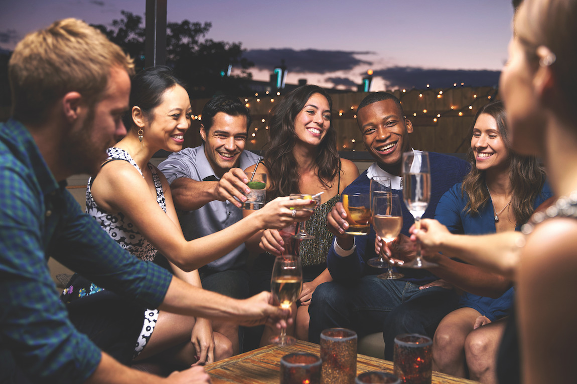 Group of friends hanging out on a rooftop deck in Jacksonville