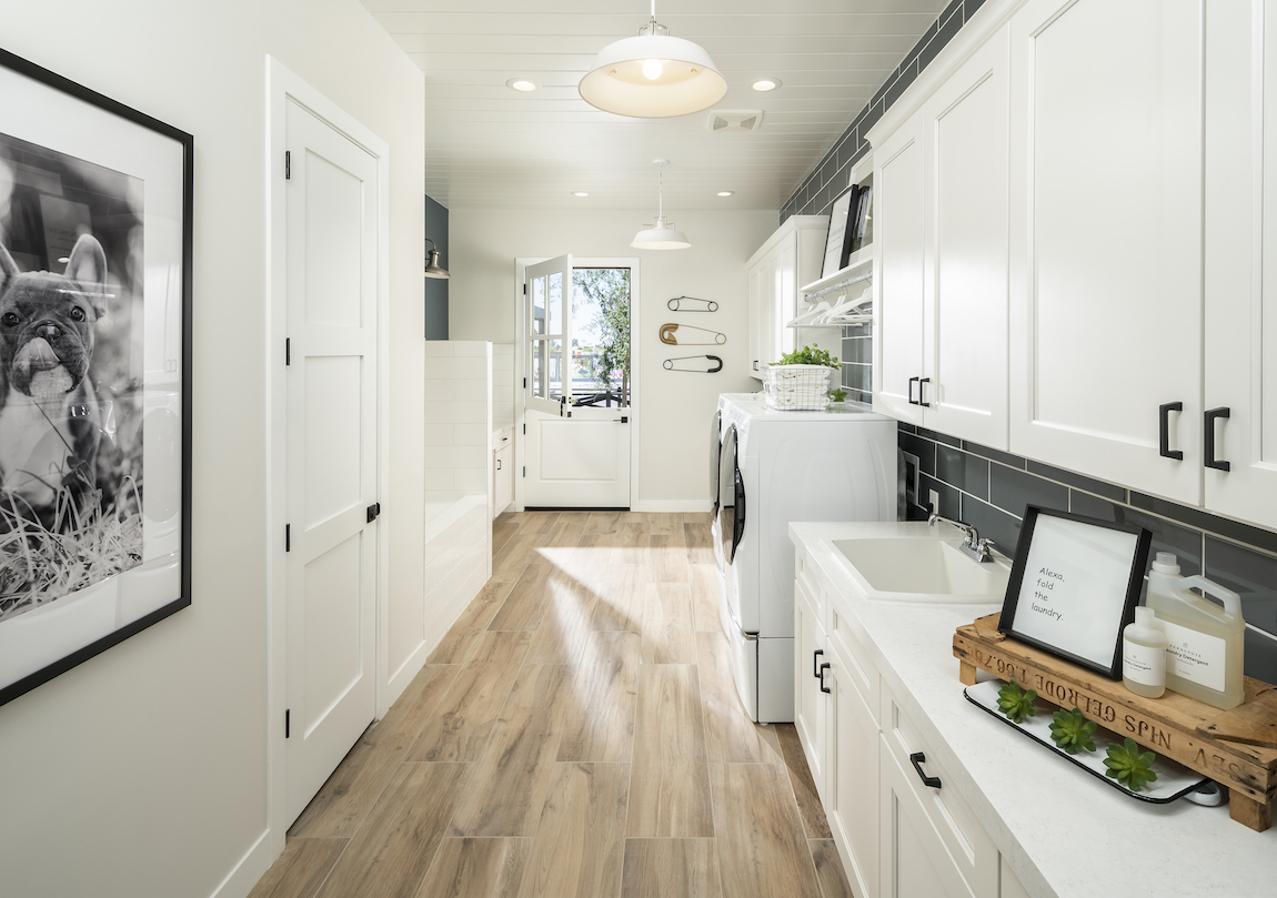 Farmhouse inspired space with barn door and rustic mudroom lighting