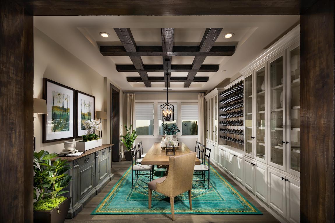 Dining room with teal area rug heightening its fall room decor